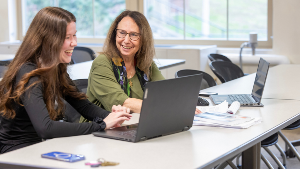 Miriam Landsman with woman looking at a laptop